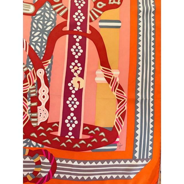 This Hermès "Fantaisie d'Etriers" scarf celebrates stirrups and the artistic creativity inherent in this equestrian...