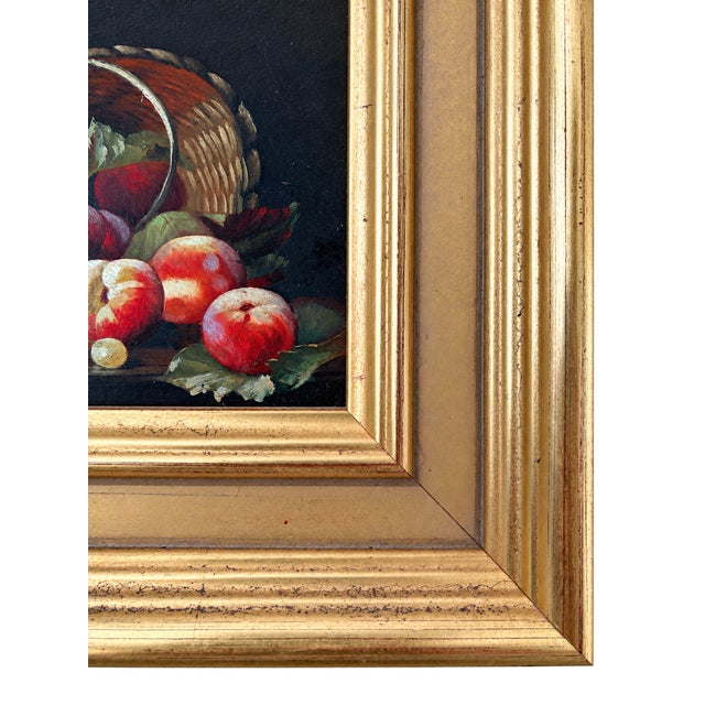 Charming petite still life depicting a tipped woven basket filled with apples and fruit, rendered in rich red, green, and...