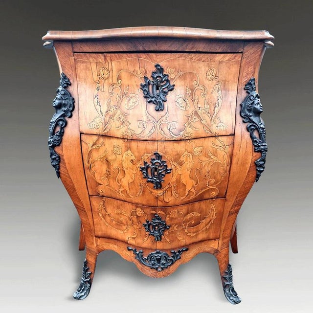An elegant Italian Venetian serpentine commode dating to circa 1800, finely constructed in walnut and enriched with...