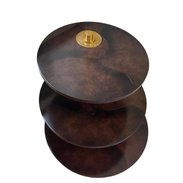 A sculptural Gin End Table by Henredon, conceived as an elegant composition of three staggered circular tiers unified by a...