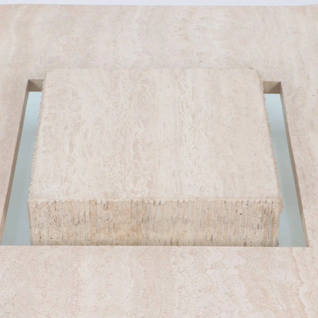 A rare Mid-Century Modern Italian travertine coffee table. The top has turned corners and is supported by a hidden thick...
