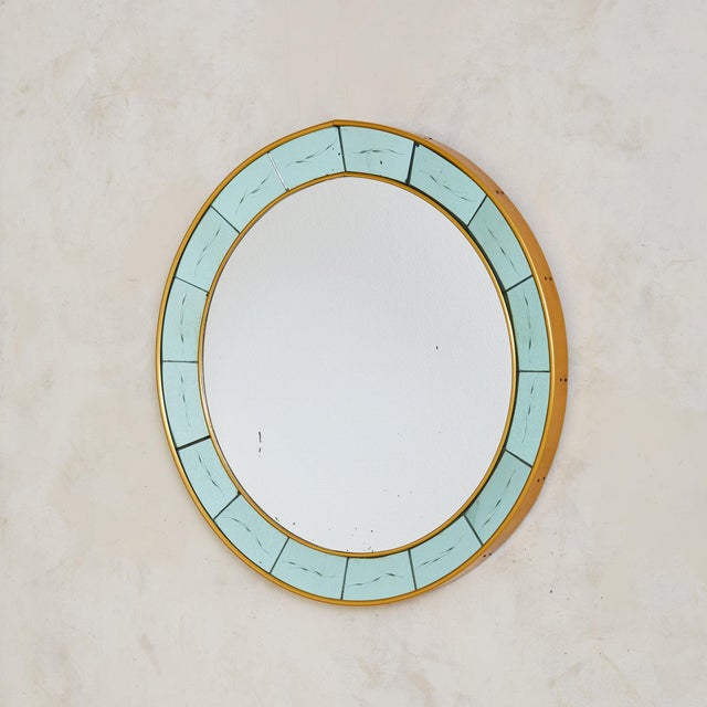 A 1960s Italian wall mirror attributed to Cristal Arte. The circular form is framed in alternating panels of etched pale...