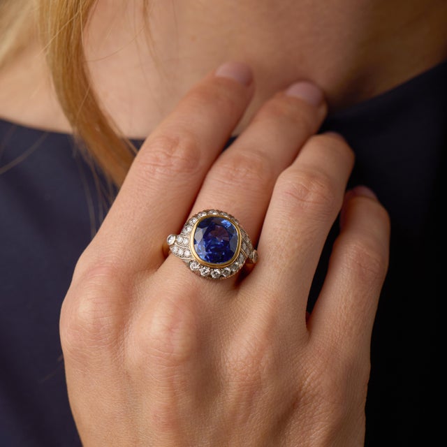 This bold French vintage cocktail ring centers on an extraordinary cushion cut blue sapphire weighing approximately 8.00...