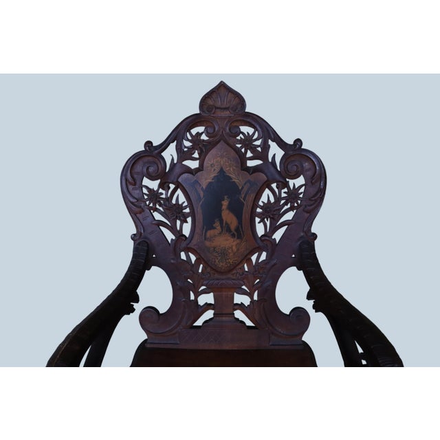 Expertly crafted 19th century black forest hunting arm chair brought over from Switzerland by a past generation. The...