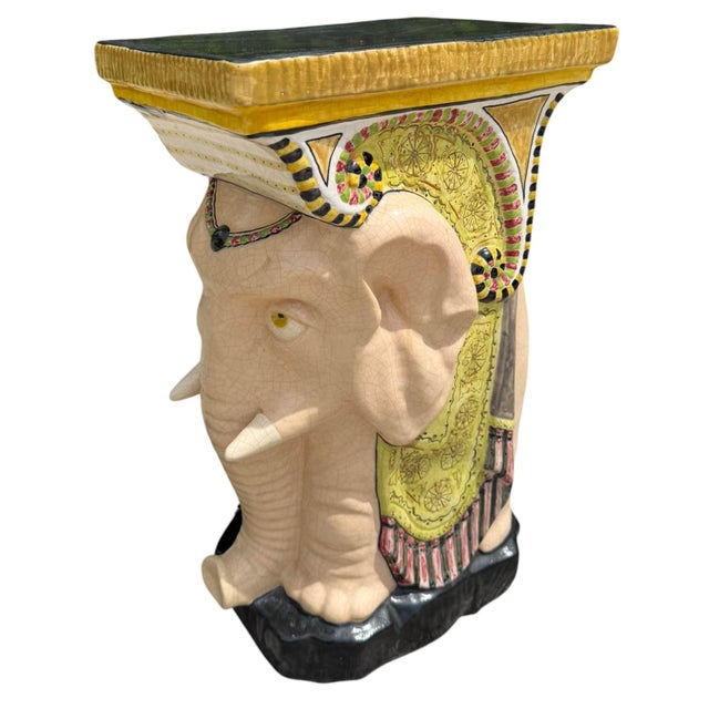 A hand-painted ceramic elephant garden stool or pedestal with an allover crackle glaze and richly detailed decorative...
