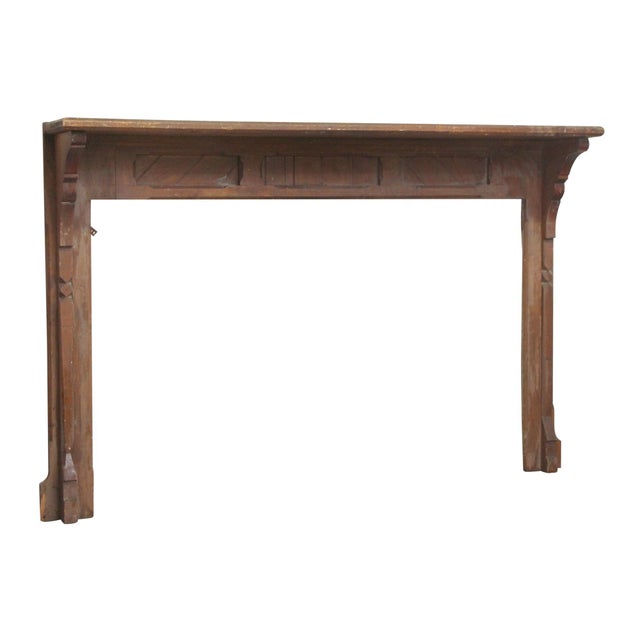 Traditional style mantel with some geometric detail. It appears to be made of pine and is most likely from the early 20th...