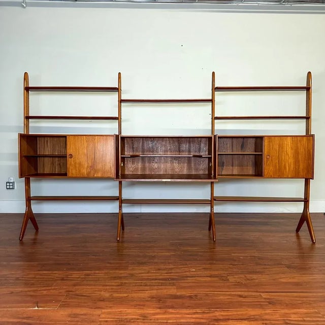 Spectacular freestanding teak three-bay wall unit or room divider with three cabinets and eight shelves, designed by Erik...