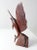 This vintage hand-carved sailfish sculpture is crafted from rich, dark ironwood and poised in a dynamic leaping pose on a...
