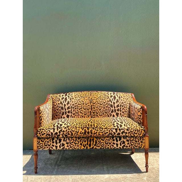This striking vintage settee masterfully blends the refined elegance of a Napoleon III silhouette with the bold,...