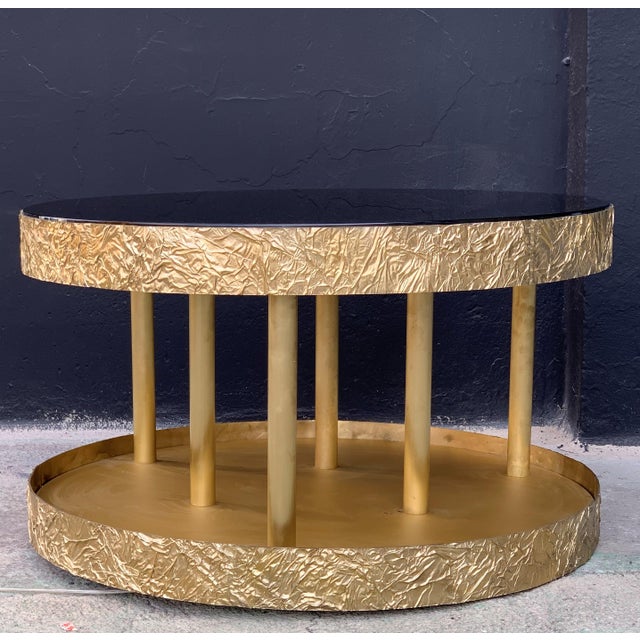 New bronze and metal round center table with black glass with low light Handmade in bronze with an unusual technical of...