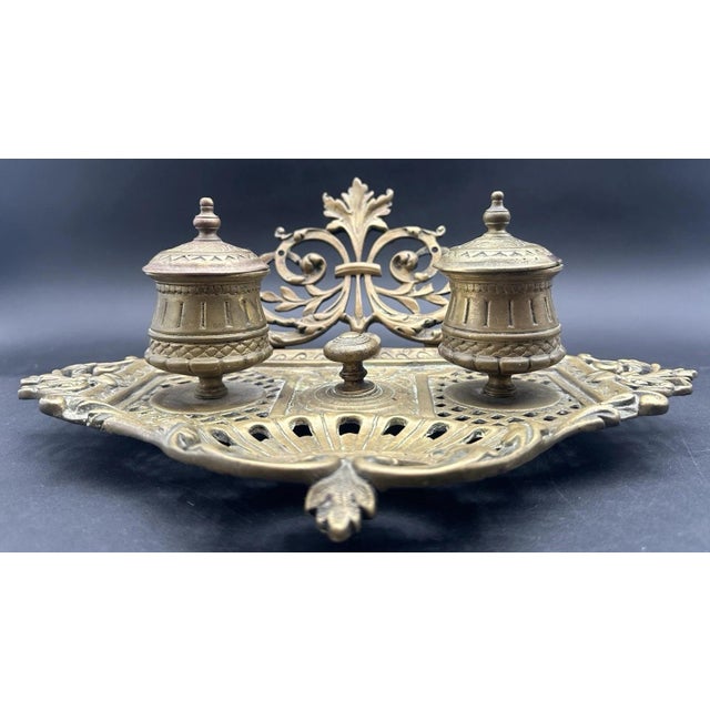Features double ink containers with lids. (No interior liners are present) Made of cast metal, most likely brass. (Metal...