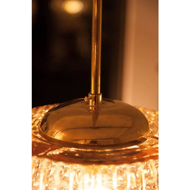 Very unique Austrian Mid-Century set of three ceiling lamps by Rupert Nikoll, Vienna, circa 1950. Orange colored glass...