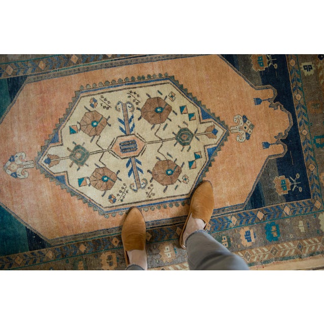 :: Oversized center medallion with simplistic primitive rendering of floral top views and ram's horn scrolled tendrils...