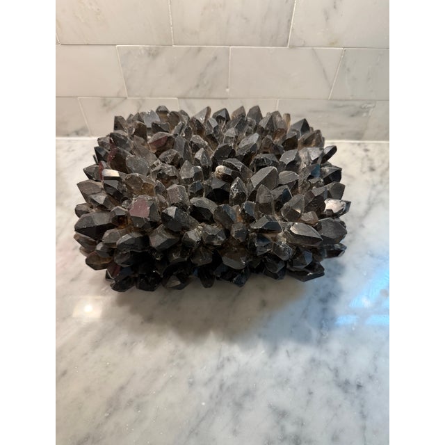 This Rock Crystal lidded box captivates with its organic beauty, a seamless marriage of raw elegance and refined...