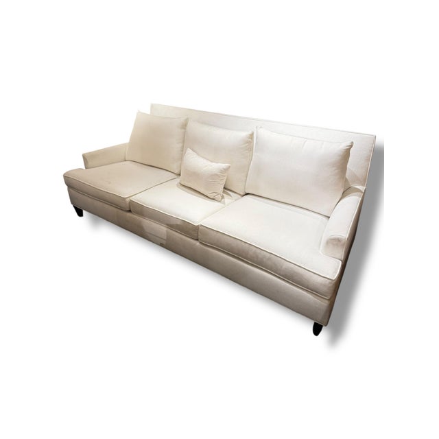 A timeless Ethan Allen sofa upholstered in a beautiful soft white/ivory fabric. The clean-lined silhouette features a...