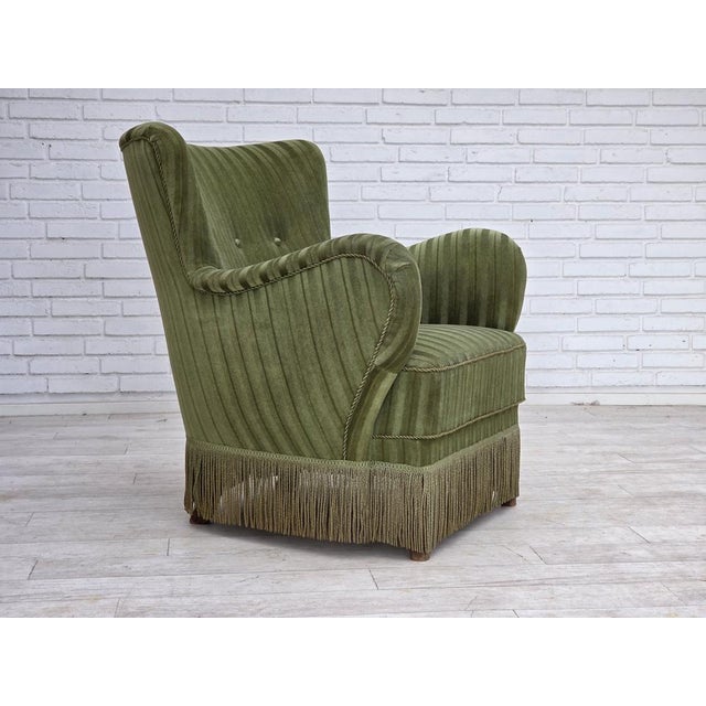 1960s, Danish armchair. Original green furniture velour, beech wood legs, brass springs in the seat. Original good...