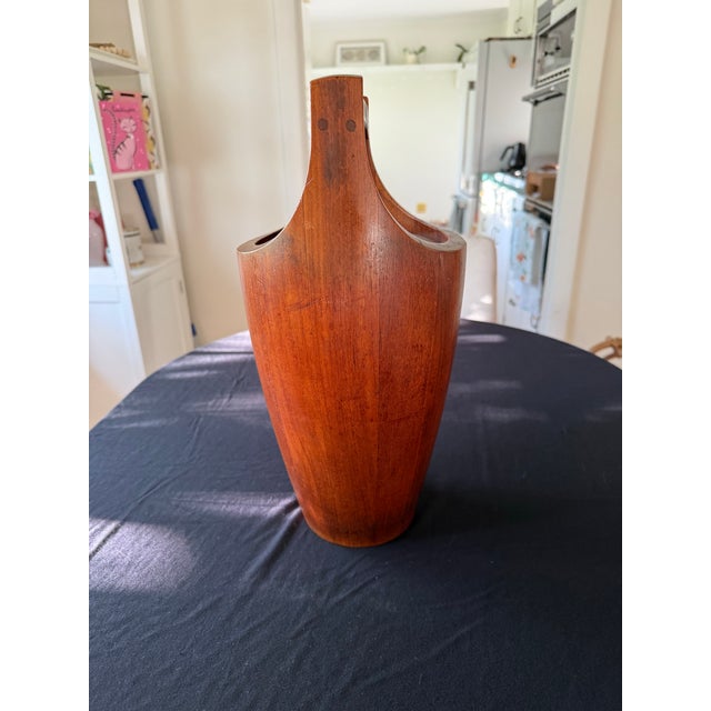A striking example of Danish Modern design at its most sculptural. This tall staved teak ice bucket was designed by the...