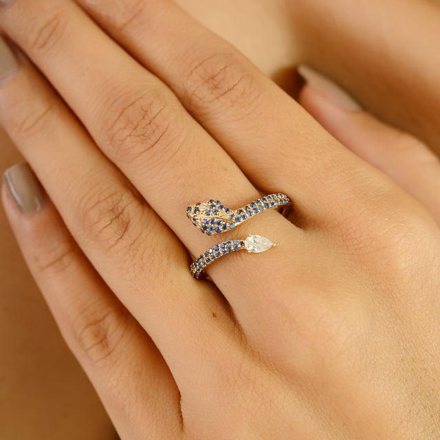 Embodying both elegance and symbolism, this captivating serpent wrap ring is handcrafted in 14k yellow gold. Adorned with...