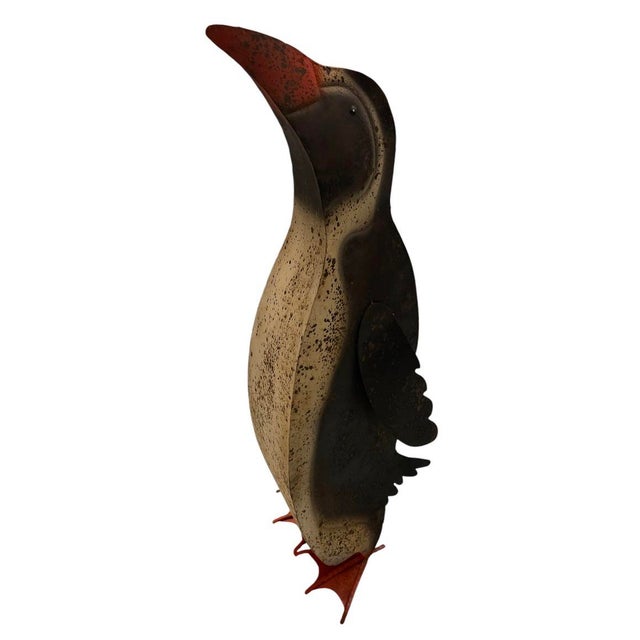 This vintage sheet metal penguin sculpture showcases a beautifully aged, weathered appearance that highlights its historic...