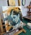 This oil painting features a profile of a young figure, rendered in a striking palette dominated by warm oranges and cool...