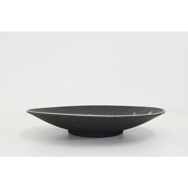Elevate your space with this captivating Oeganda Signed Mid Century Pottery Bowl, exclusively available at circa20c. Its...