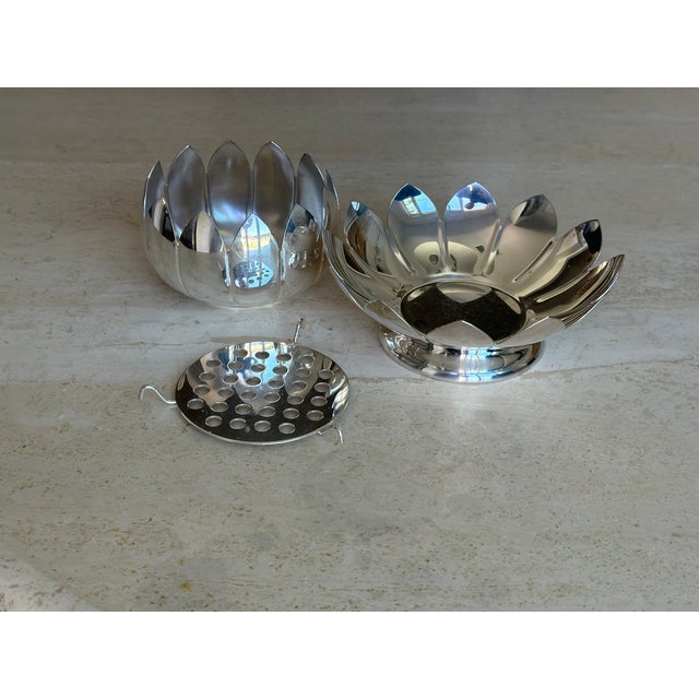 A sculptural Reed & Barton silver-plated lotus flower frog — the layered petal form doubles as a stunning decorative...