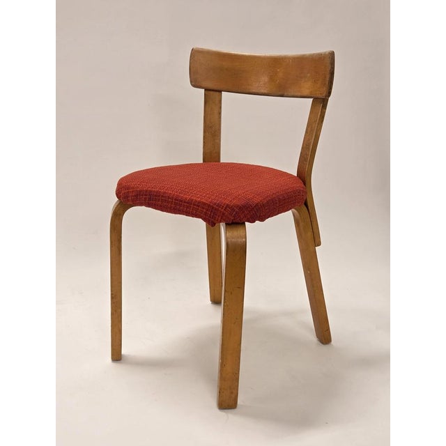 Artek 69 chair, birch with red upholstery. The chair is from around 1940-1950. Old Artek stamp on the base. Gorgeous...