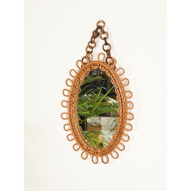 Wonderful and incredibly stylish Mid-Century organic oval mirror with an adjustable or removable chain, entirely made of...