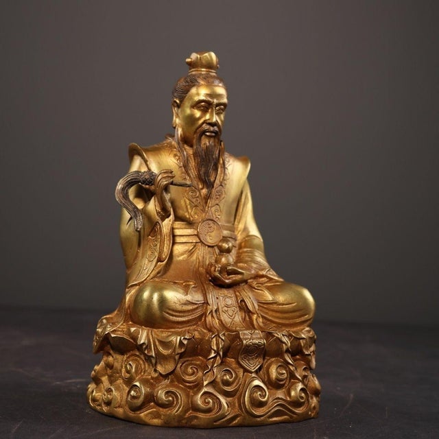 This is a finely crafted antique gilt bronze sculpture of Tai Shang Lao Jun, a revered high deity in Taoism. The figure is...