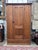 Late 19th-century Eastlake wardrobe, circa 1880s, crafted from poplar, pine, and cherry and finished in a rich walnut...