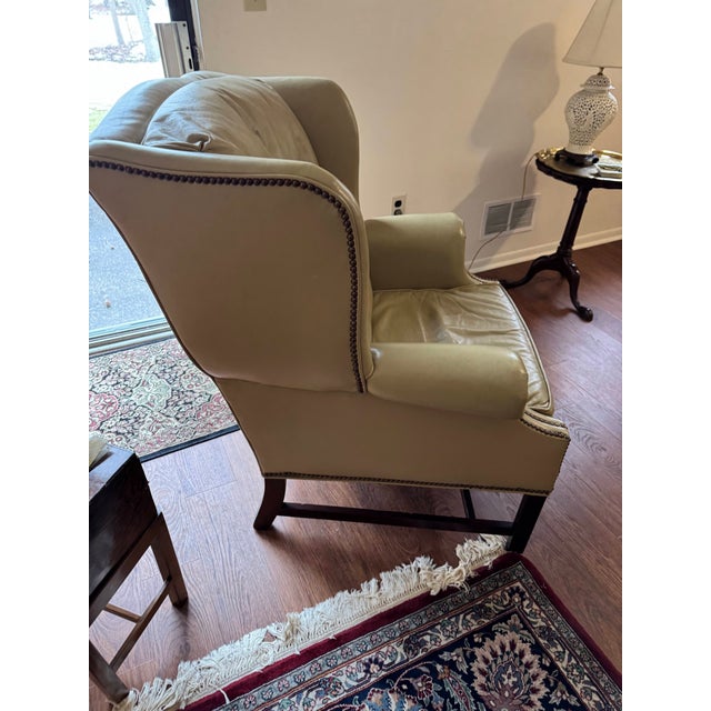 This premium vintage armchair and matching ottoman set from Classic Leather Inc. perfectly balances sophisticated...
