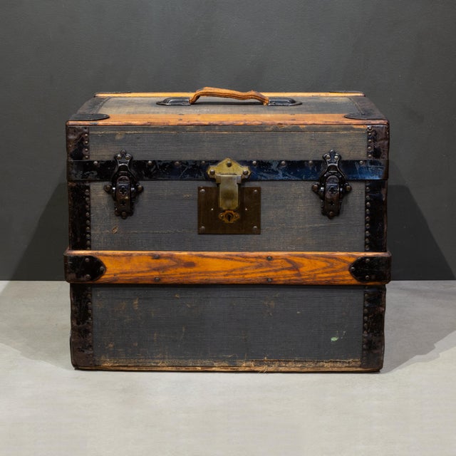 ABOUT A 19th century wood, steel and canvas small cabin trunk or travel chest with large brass lock. This compact size was...