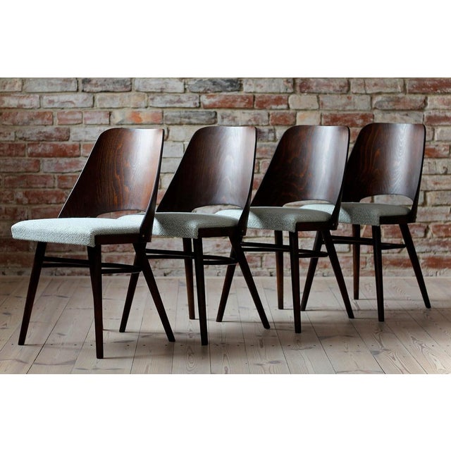 This set of four vintage dining chairs was designed by Czech designer Radomir Hofman in the 1960s. Produced by TON. The...
