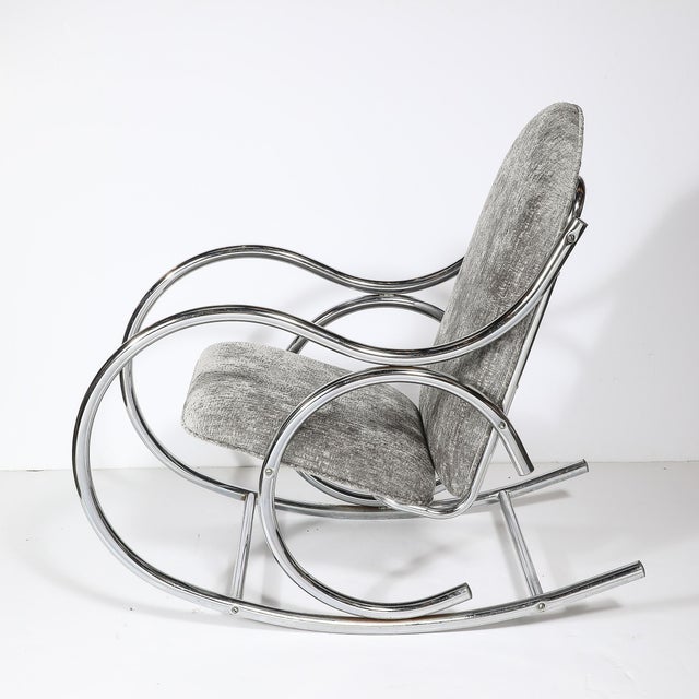 This striking mid-century modernist tubular chrome rocking chair, crafted in America circa 1970, is a study in innovative...