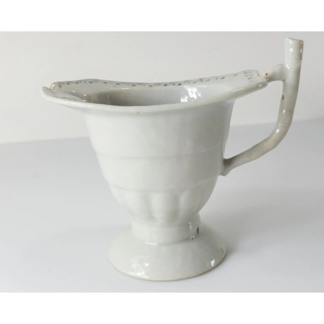 We are selling this Chinese export porcelain helmet creamer form pitcher with simple black or grisaille decoration....