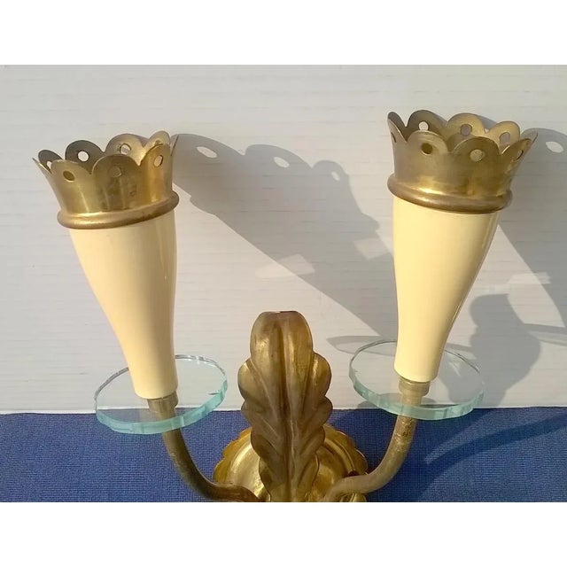 Set of three sconces in brass and glass, manufactured in Italy in the 1940s by Arredoluce, designer Angelo Lelii. Very...