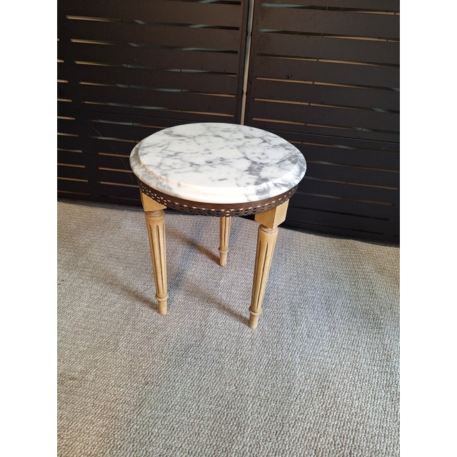 A Louis XVI style pedestal with a DMC Portugal marble top. This table has a circular marble top of white with grey...