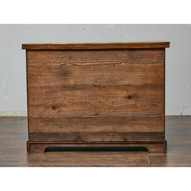 With its richly figured surfaces and architectural detailing, this English writing cabinet from the 19th century is full...