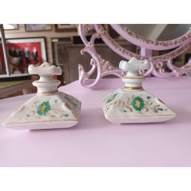 These are a splendid set of vintage square French perfume bottles crafted from delicate porcelain and adorned with hand-...