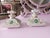 These are a splendid set of vintage square French perfume bottles crafted from delicate porcelain and adorned with hand-...