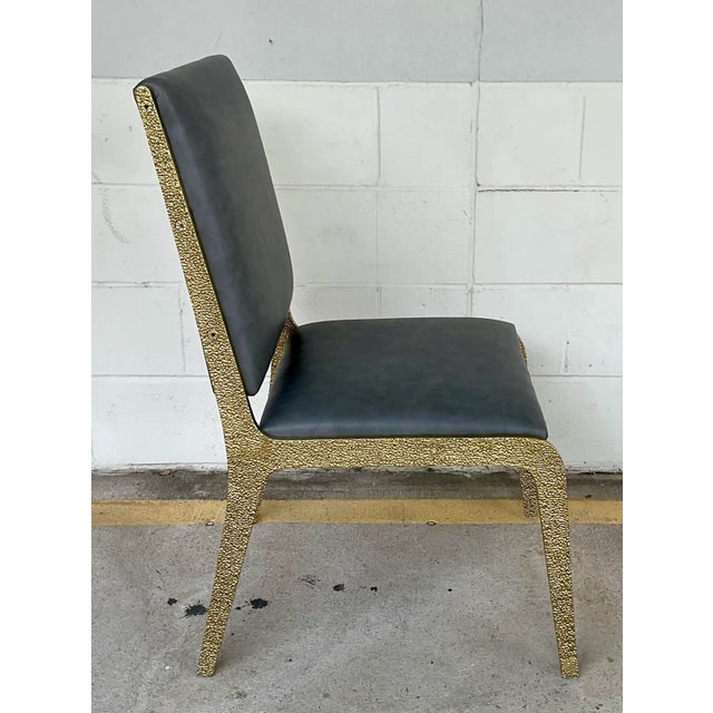 Stylish and custom Baker Contemporary Solid Textured Brass Side Chair, buttery gray vinyl upholstery, showroom floor sample