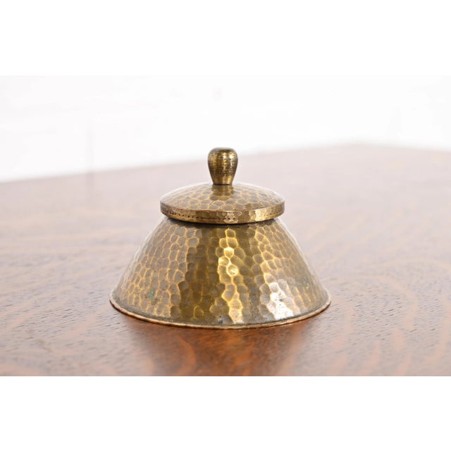 A gorgeous Arts & Crafts period brass finished hand hammered copper inkwell By Roycroft (signed with impressed orb and...