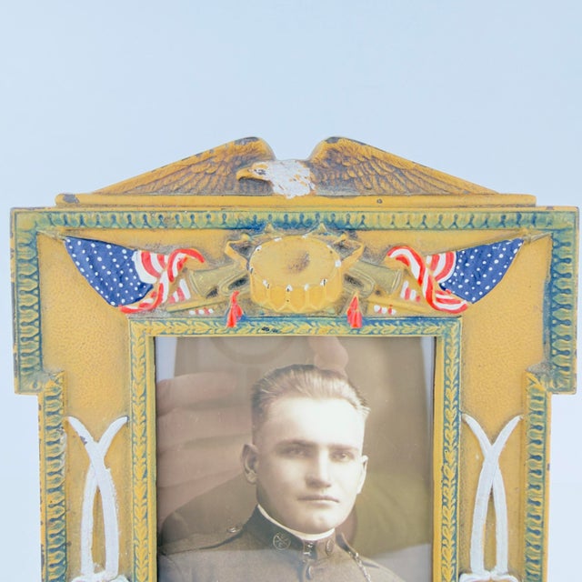 This is an outstanding WWI cast‑iron military picture frame, dated 1917, featuring a highly detailed patriotic motif. The...