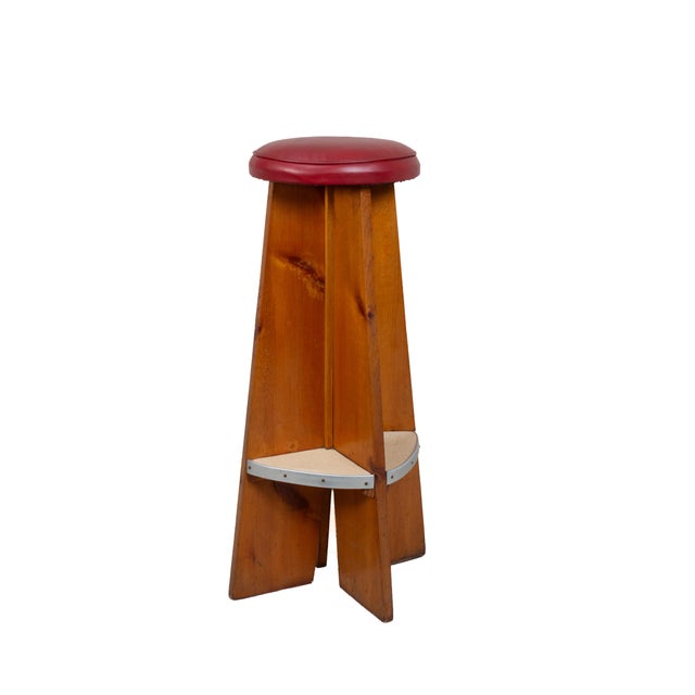 Set of three mid-century bar stools in solid knotty pine. No maker's marks; these appear to be studio- or home-made, with...
