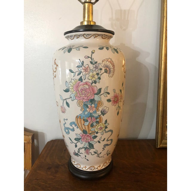 This is a stunning, tall lamp with enameled florals in peach, blue ,green and yellow on a creamy background. The top is...