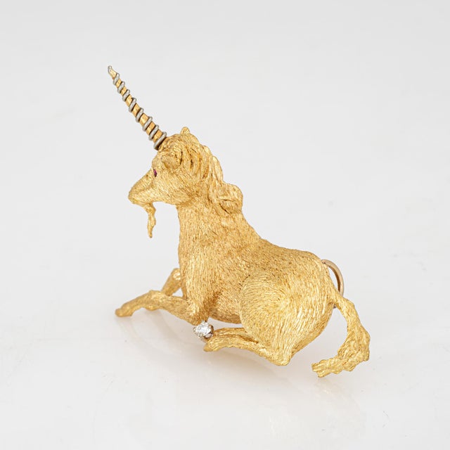 Unique & stylish vintage Unicorn pendant crafted in 18 karat yellow gold (circa 1970s). One estimated 0.05 carat diamond...
