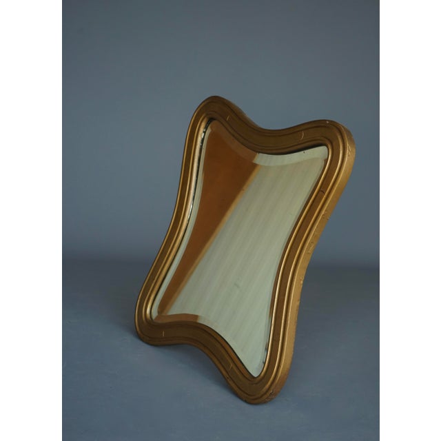 Stylish wall mirror. Gold painted wooden frame and pine back. Original period mirror glass with bevelled edge that gives a...