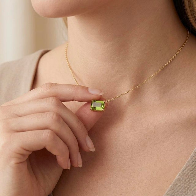 Embrace the crisp, refreshing beauty of nature with this striking East-West Emerald Cut Peridot Necklace. This...