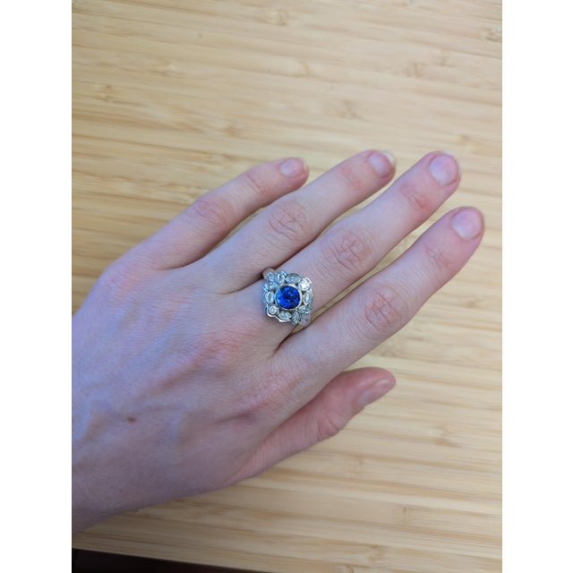 This dazzling 2.13-carat Ceylon sapphire ring brings vintage drama with its elegant bezel setting, ornate marquise and...
