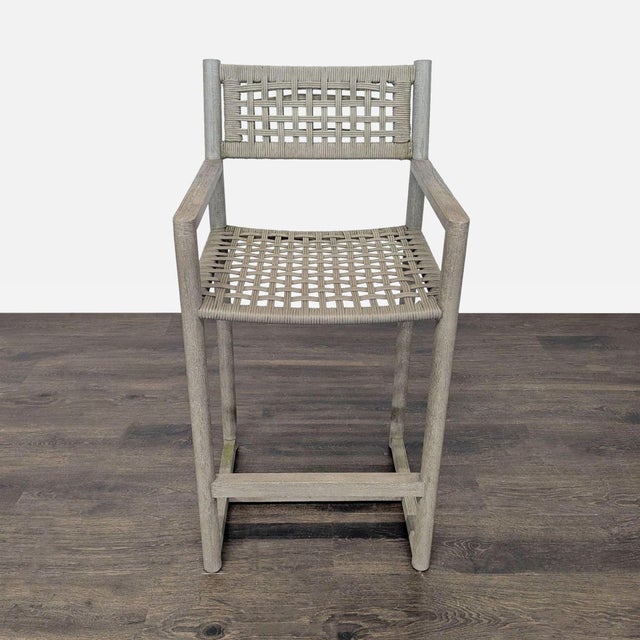 This Restoration Hardware bar chair features a sturdy teak wood frame and a woven seat and backrest for a stylish, modern...